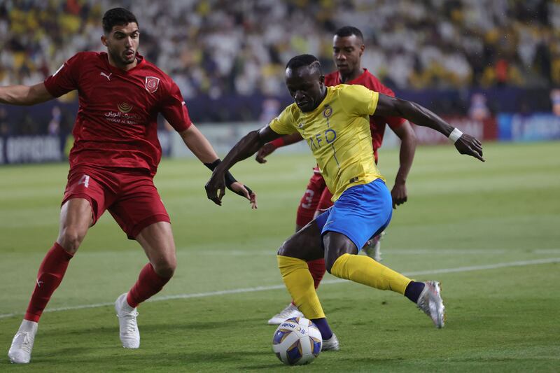 Al Nassro forward Sadio Mane takes on Al Duhail defender Yousef Aymen. AFP