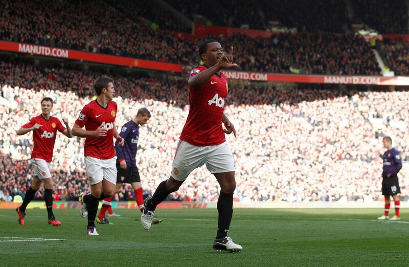 Manchester United's Patrice Evra, center, celebrates after scoring against Arsenal during their English Premier League soccer match at Old Trafford Stadium, Manchester, England, Saturday, Nov. 3, 2012. (AP Photo/Jon Super) *** Local Caption ***  Britain Soccer Premier League.JPEG-09a51.jpg