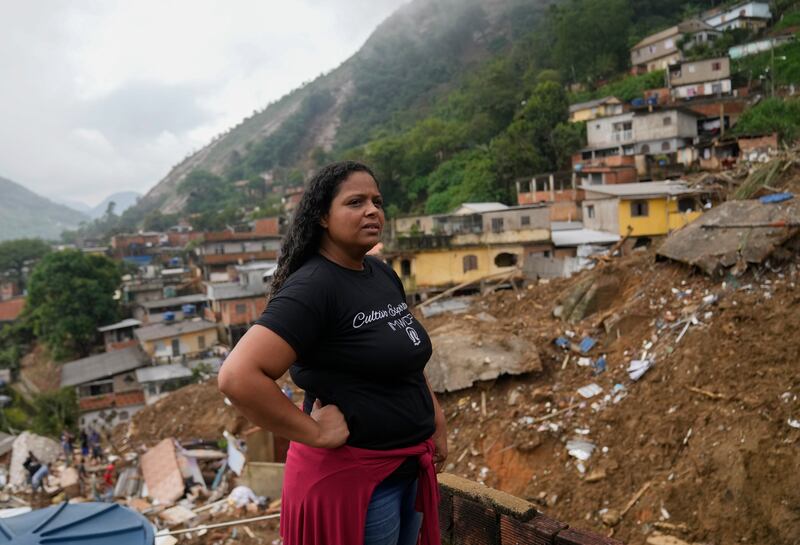 Priscilla Neves waits for news about her missing parents, who were in their family home when it was covered by mudslides. AP