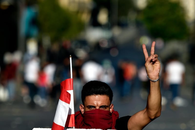 A man carries the national flag during the protests. EPA