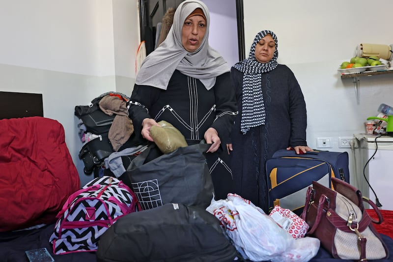 Ms Abu Obeida and Ms Abu Shaaban stash food into their luggage at the hotel near Augusta Victoria Hospital. AFP