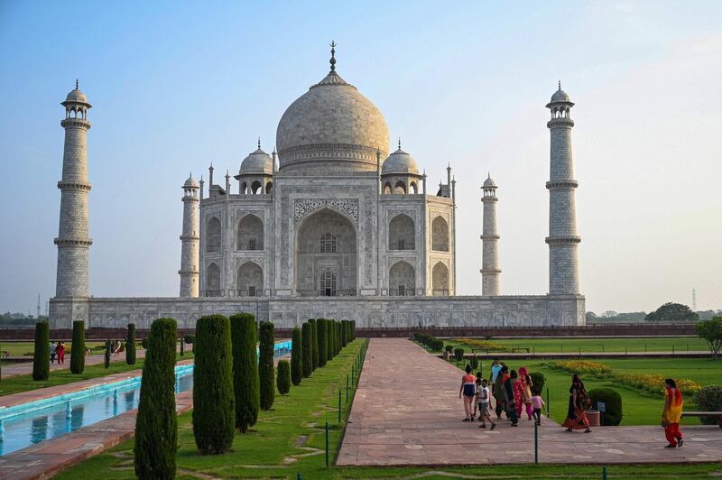 Tourists visit the Taj Mahal after it reopened to visitors following authorities easing Covid-19 coronavirus restrictions in Agra. AFP