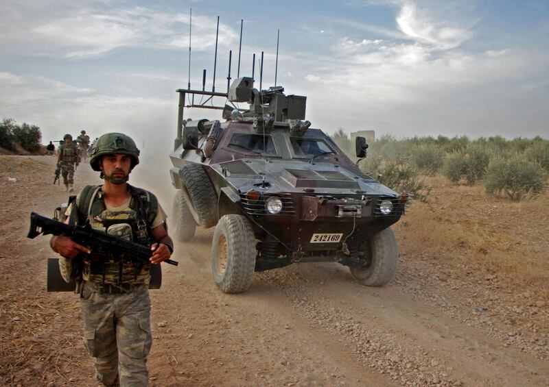 Turkish troops walk alongside an armoured personnel carrier through the town of Tukhar, north of Syria's northern city of Manbij, as Turkey and it's allies continues their assault on Kurdish-held border towns in northeastern Syria.
 Turkey wants to create a roughly 30-kilometre (20-mile) buffer zone along its border to keep Kurdish forces at bay and also to send back some of the 3.6 million Syrian refugees it hosts. AFP