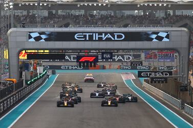 ABU DHABI, UNITED ARAB EMIRATES - NOVEMBER 20: Max Verstappen of the Netherlands driving the (1) Oracle Red Bull Racing RB18 and Sergio Perez of Mexico driving the (11) Oracle Red Bull Racing RB18 lead the field into turn one at the start during the F1 Grand Prix of Abu Dhabi at Yas Marina Circuit on November 20, 2022 in Abu Dhabi, United Arab Emirates. (Photo by Mark Thompson / Getty Images)