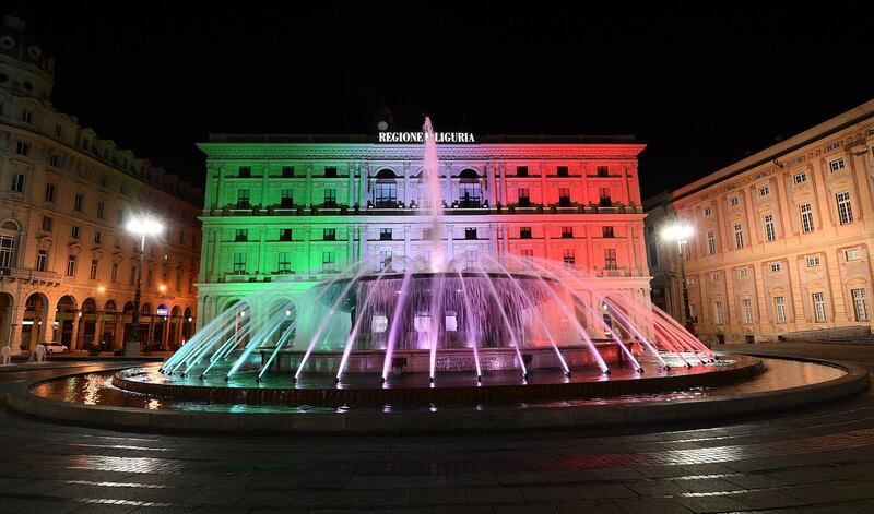 The palace of Liguria region in the De Ferrari square is illuminated with the tricolor lights of the Italian flag, in a national tribute amid the coronavirus epidemic in Genoa, Italy, 21 March 2020. EPA