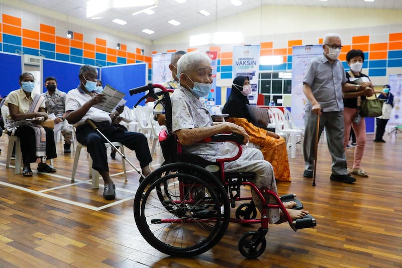 An elderly woman waits for her turn to receive a dose of Pfizer-BioNTech coronavirus vaccine in Port Klang, on the outskirts of Kuala Lumpur, Malaysia. EPA