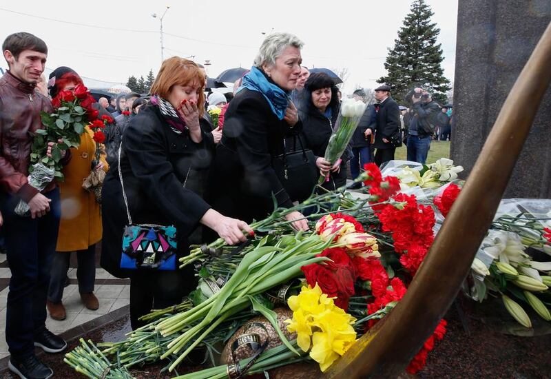 Relatives and fellow mourners lay flowers at a Russian memorial to the 62 people killed when a flydubai Boeing 737-800 crashed in bad weather at Rostov-on-Don airport after an abortive landing attempt last year. Valery Matytsin / Tass / Getty Images