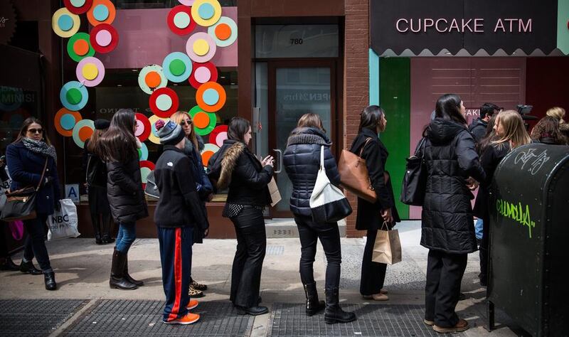 People wait in line to try out the Cupcake ATM.