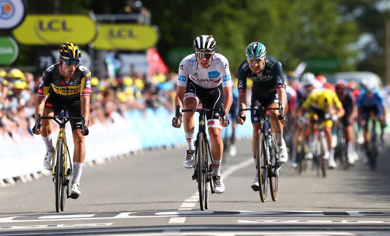 Slovenian rider Tadej Pogacar, centre, of the UAE-Team Emirates and Primoz Roglic, left, of the Jumbo Visma team cross the finish line during the second stage of the Tour de France. EPA