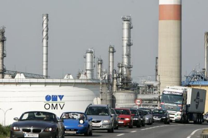 Cars pass by Austria's largest raffinery plant OMV 10 May 2006 in the Schwechat suburb of Vienna. The Austrian oil group OMV and electricity company Verbund said today that they have signed a merger agreement to create the biggest energy group in central Europe. The deal is to result in a new European energy giant with capitalisation of 29.5 billion euros (37.8 billion dollars), more than 18 billion euros in combined sales and 52,000 employees. AFP PHOTO / JOE KLAMAR OMV, the Austrian energy firm is 20 per cent owned by IPIC