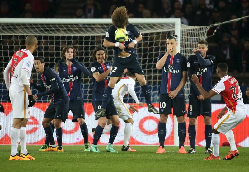 Paris St Germain’s David Luiz jumps to head the ball during a free kick against Monaco. Charles Platiau / Reuters