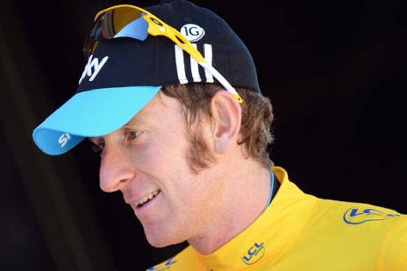 Tour de France winner Bradley Wiggins celebrates after retaining the yellow jersey
