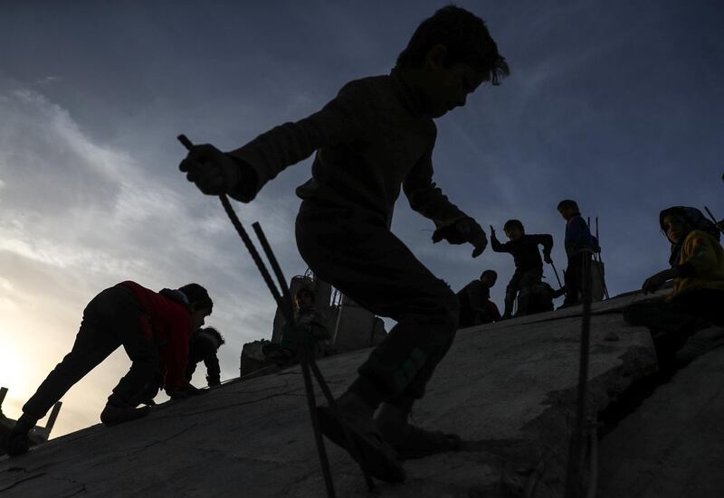 Children play on a destroyed house next to destroyed mosque in al-Nashabieh City, Syria. Mohammed Badra / EPA