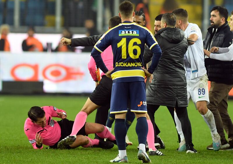 Referee Halil Umut Meler falls down after being punched by Ankaragucu president Faruk Koca. AP