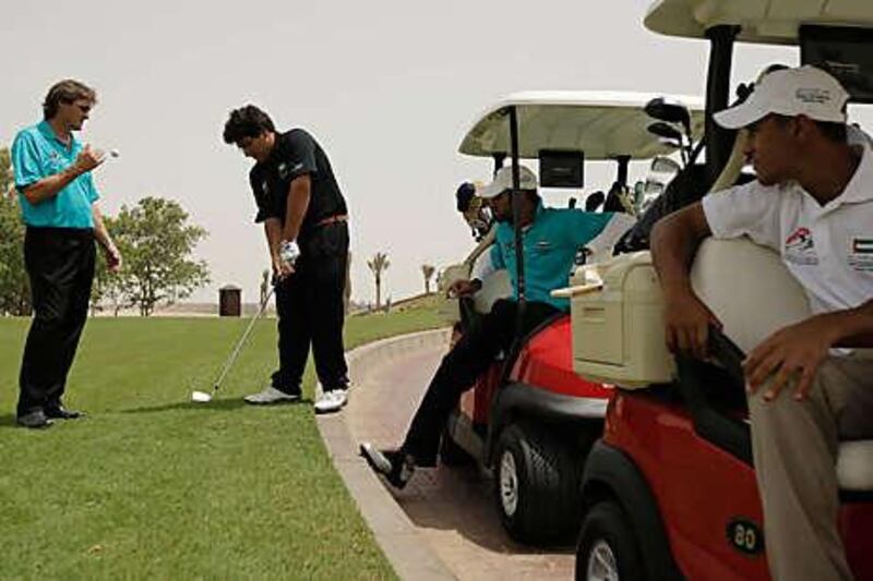 Khalid Yousuf, 19, is considered the UAE's best golfer. He and his teammates Ahmed, right, and Abdullah al Musharrekh, far right, play at Abu Dhabi Golf Club.
