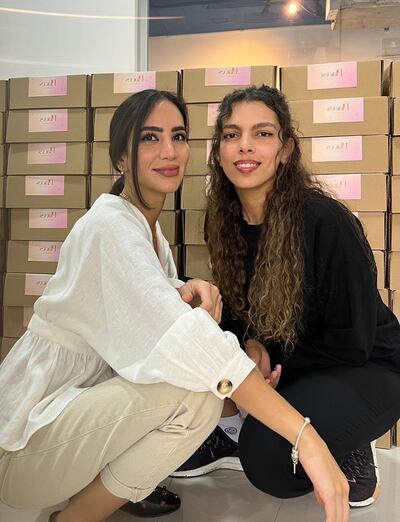 Shatha Batterjee, left, and Hala Khallaf, pose with Valentine's Day gift boxes created by their Saudi lifestyle brand Places by Us.