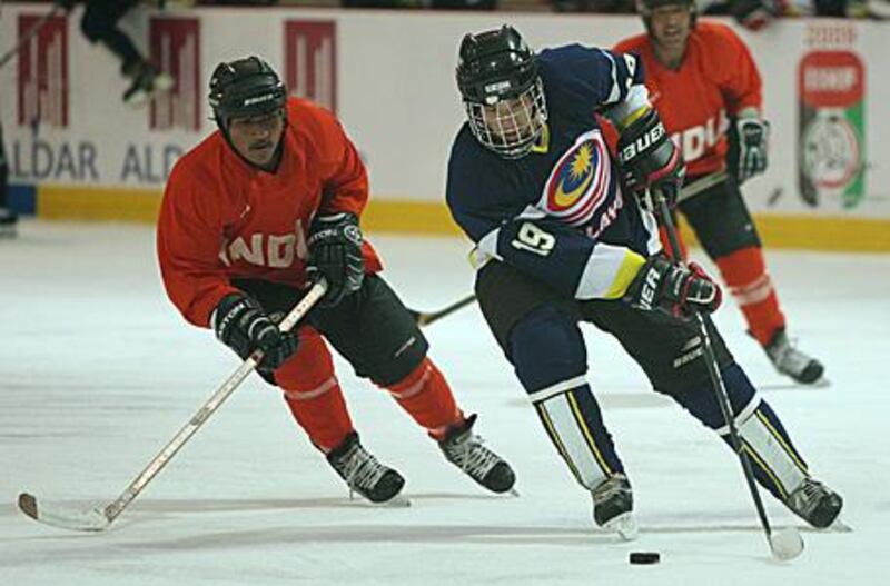 Jamil David bin Ahmad Mokhar of Malaysia skates with the puck during his side's 10-1 win over India.
