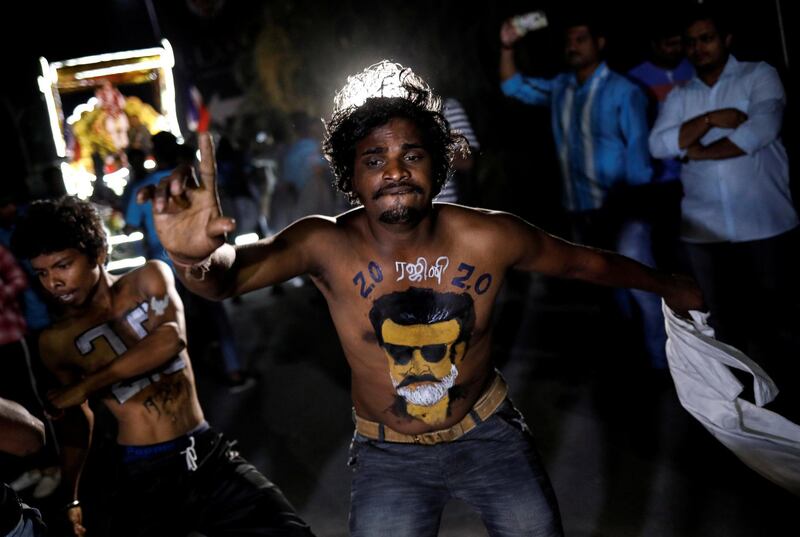 A fan with his body painted with image of Rajinikanth dances. Reuters