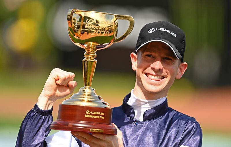 Jye McNeil celebrates with the trophy after winning the Lexus Melbourne Cup. Getty Images for the VRC