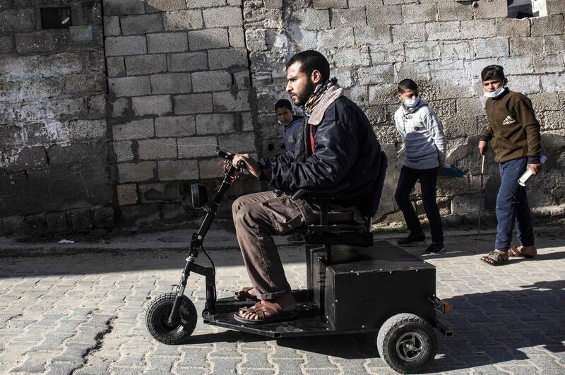 Abu Raida test-rides a small electric vehicle he assembled. AFP
