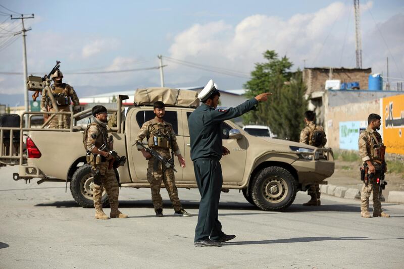 Afghan security personnel arrive outside a mosque after a bomb explosion during Friday prayer on the outskirts of Kabul, Afghanistan, Friday, May 24, 2019.  According to Kabul police chief's spokesman, Basir Mujahid, the bomb was concealed in the microphone used to deliver the sermon. The prayer leader, Maulvi Samiullah Rayan, was the intended target, the spokesman added. (AP Photo/Rahmat Gul)