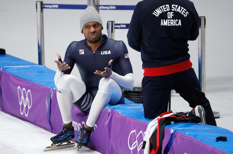 Shani Davis of the United States, left, speaks with his team member during a speed skating training session prior to the 2018 Winter Olympics in Gangneung, South Korea, Friday, Feb. 9, 2018. (AP Photo/John Locher)