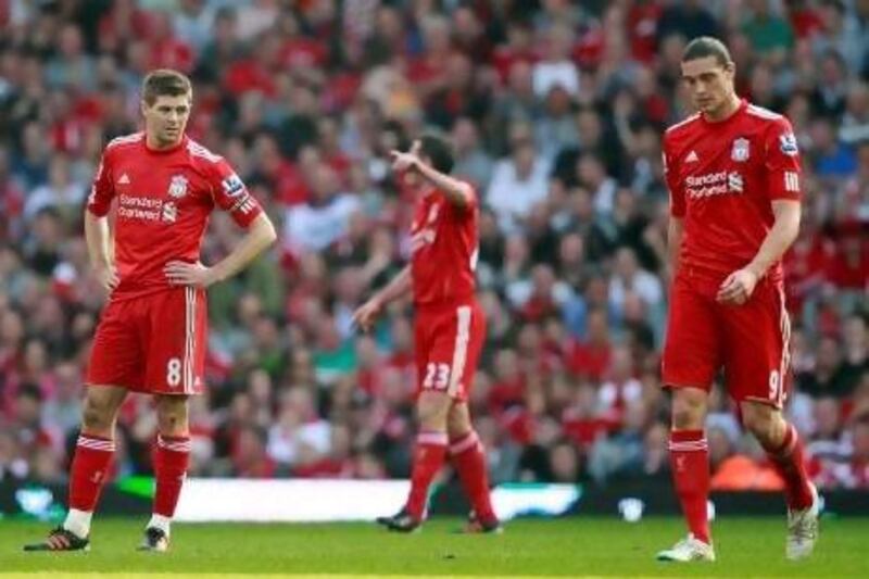 Steven Gerrard, left, the Liverpool captain and Andy Carroll, right, who at £35 million represents Kenny Dalglish's most expensive signing in his second stint as manager. Liverpool lost 2-1 at home to lowly Wigan Athletic at Anfield on Saturday, prompting the manager to cite tiredness as a reason. Tim Hales / AP Photo