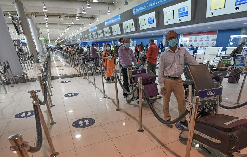 Indian nationals queue to check in at the Dubai International Airport before leaving the Gulf Emirate on a flight back to her country, on May 7, 2020, amid the novel coronavirus pandemic crisis.  The first wave of a massive exercise to bring home hundreds of thousands of Indians stuck abroad was under way today, with two flights preparing to leave from the United Arab Emirates.
India banned all incoming international flights in late March as it imposed one of the world's strictest virus lockdowns, leaving vast numbers of workers and students stranded.

  


  
 / AFP / Karim SAHIB
