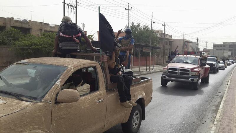 Fighters of the Islamic State celebrate in Mosul on June 12, 2014, days after capturing the city. Reuters