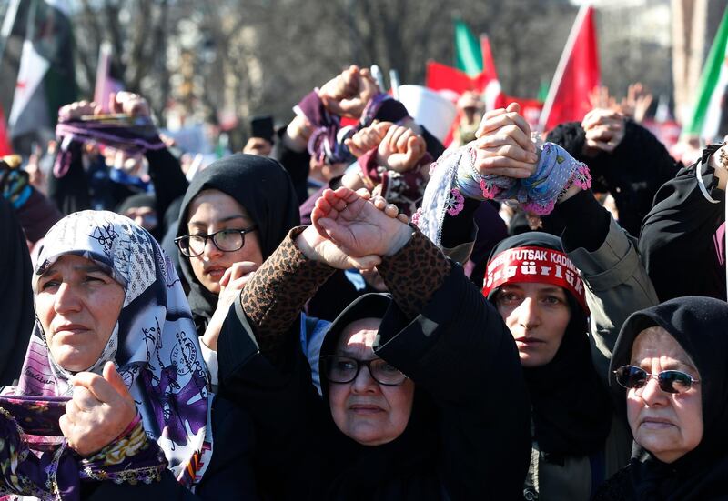 Women protest in Istanbul, Friday, March 8, 2019, against the imprisonment of women and children in Syrian penitentiaries. Hundreds of demonstrators, some of them with hands bound symbolising captivity, called for the release of the women and children during the event which coincided with International Women's Day. (AP Photo/Lefteris Pitarakis)