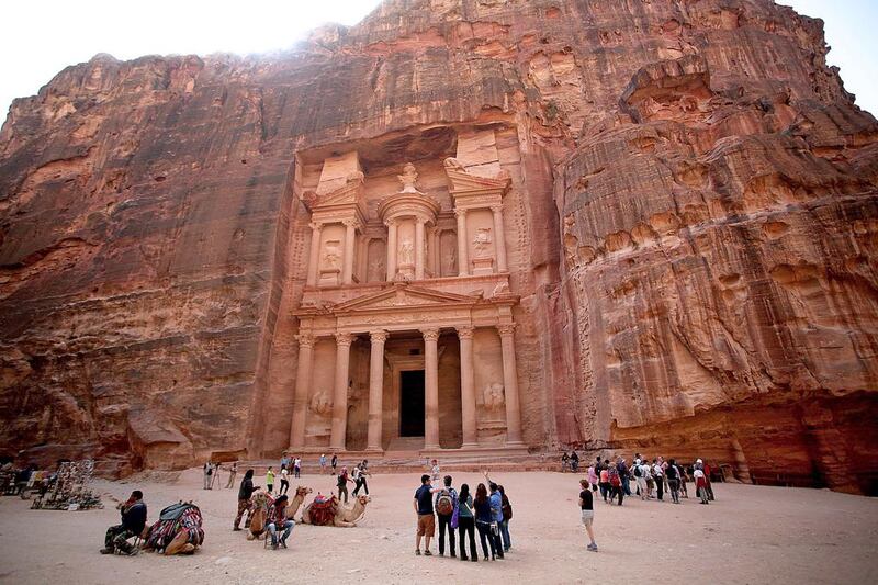 8th: Jordan. Tourists stand in front of the rock-hewn Al Khazneh, Arabic for the Treasury, in the ancient city of Petra. Mohammad Hannon / AP Photo
