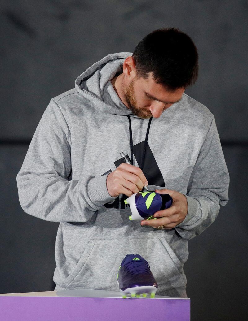 Barcelona's Lionel Messi presents his new boots in Barcelona. Reuters