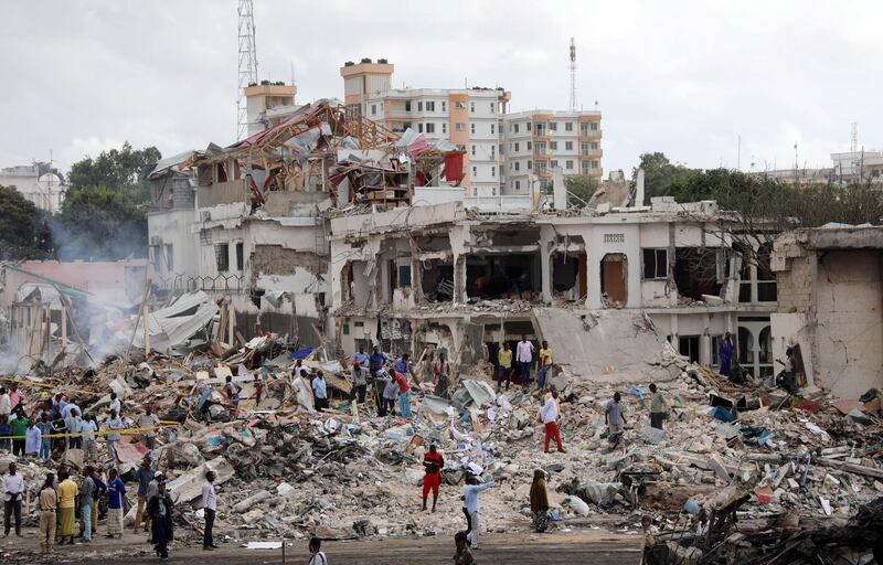 Somali government forces and civilians gather at the scene. Feisal Omar / Reuters