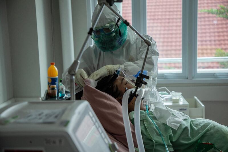 A medical staff treats a Covid-19 patient at a hospital's intensive care unit in Bogor, Indonesia. AFP