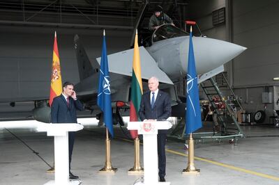 Lithuanian President Gitanas Nauseda (right) and Spanish Prime Minister Pedro Sanchez react as Lithuanian airforce pilots scramble during a press conference at Military Air Base in Sauliai, Lithuania. Valda Kalnina / EPA