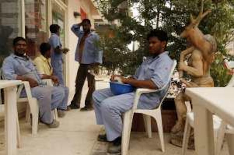 ABU DHABI, UNITED ARAB EMIRATES - July 6, 2009: (right)  Isur Tarik a construction worker from Sri Lanka and other labourers take their midday break at Al Basha Cafeteria in Abu Dhabi.  ( Ryan Carter / The National ) *** Local Caption ***  RC007-LabourBreak.JPG