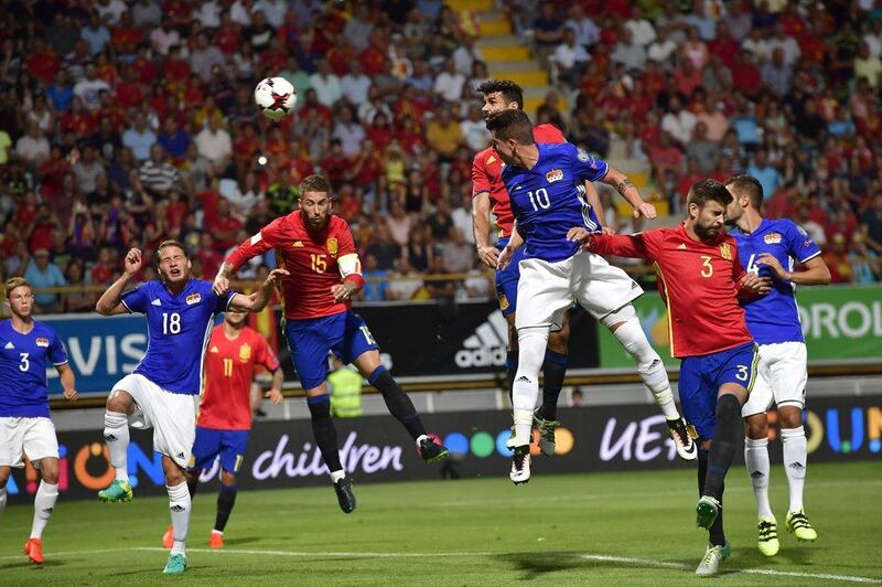Spain striker Diego Costa heads the ball to score the opening goal. Alvaro Barrientos / AP Photo