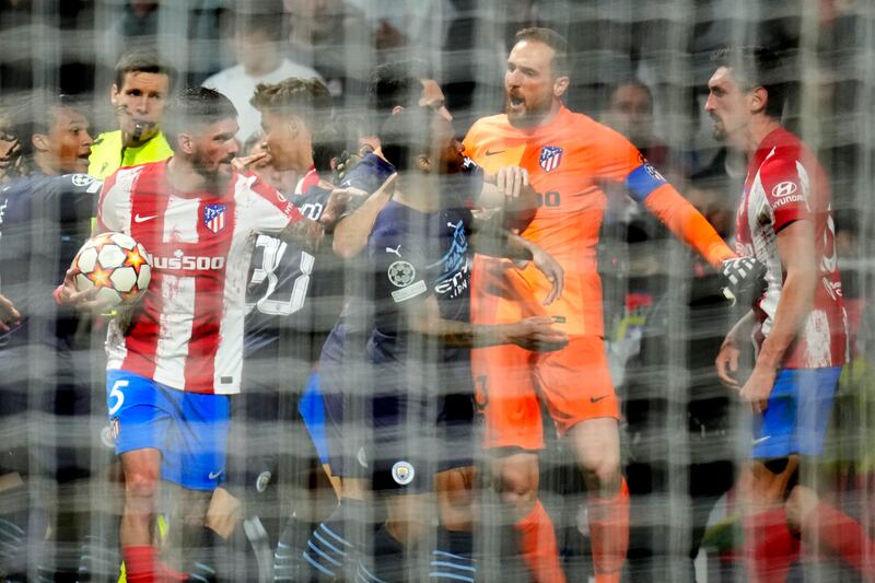 Atletico Madrid's goalkeeper Jan Oblak argues with City players. AP