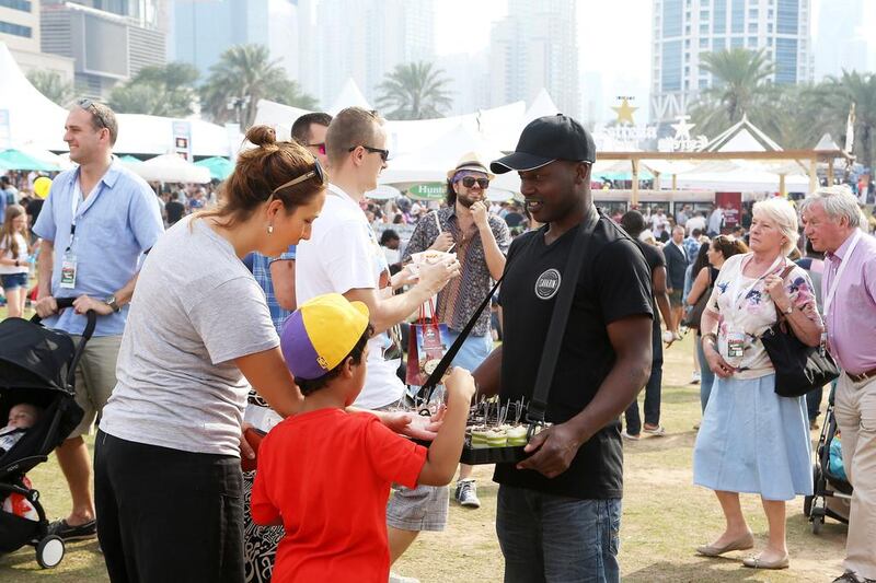 People trying different types of food at the taste of Dubai 2016 held at Dubai Media City Amphitheater in Dubai. (Pawan Singh / The National 