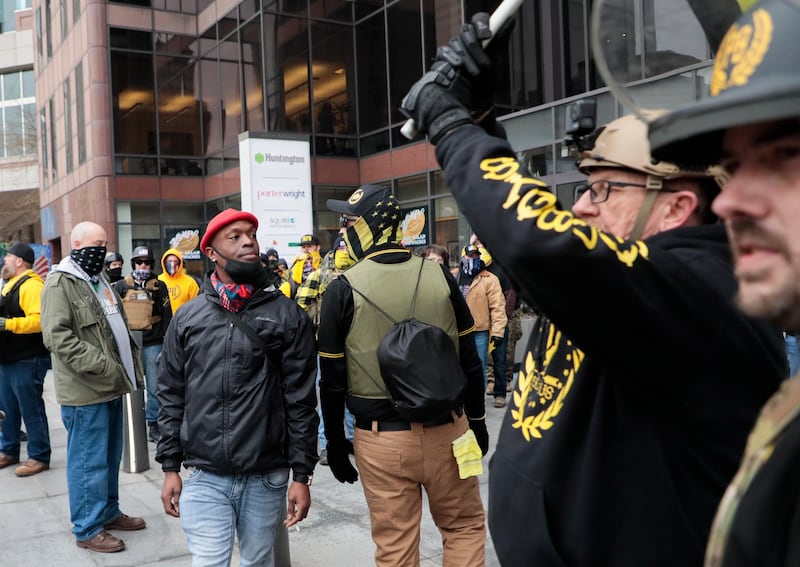 Members of the Proud Boys and counter protesters engage with each other during a rally on Wednesday, Jan. 6, 2021, at the Ohio Statehouse in Columbus, Ohio. Hundreds of supporters of President Donald Trump, including members of the Proud Boys, a far-right, male-only political organization, came to the Statehouse to protest the congressional certification of Democratic president-elect Joe Biden. (Joshua A. Bickel/The Columbus Dispatch via AP)