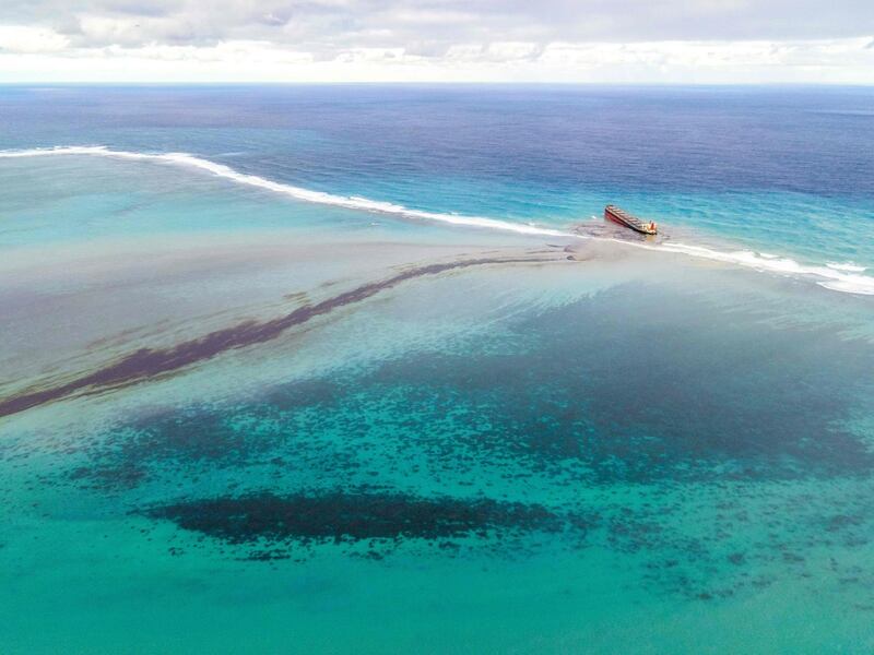 An aerial photograph shows oil drifting ashore over coral reefs from the MV Wakashio.  AFP