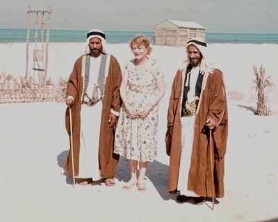 Sheikh Shakhbut bin Sultan, Ruler of Abu Dhabi and Sheikh Khalid on their visit to the expatriate community in Abu Dhabi on Christmas Day 1957. The woman is a visiting American journalist, Molly Thayer.