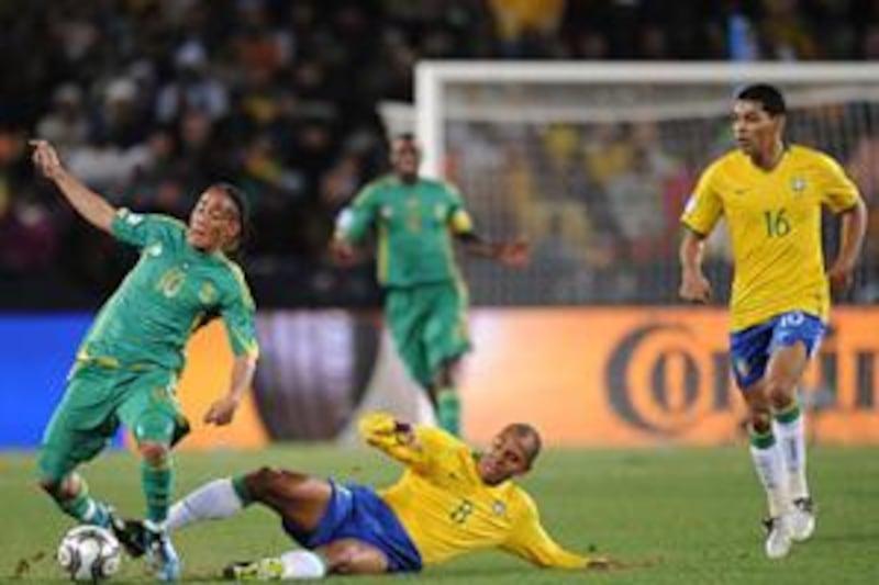 South Africa's Steven Pienaar, left, is fouled by Brazil's Gilberto Silva, No 8, during the Confederations Cup semi-final on June 25.