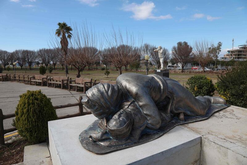 A statue depicting a Kurdish father holding his baby, both killed in the 1988 Halabja Chemical attack, part of a memorial monument dedicated to the victims of the attack in the Kurdish town, 300 kms (190 miles) northeast of Baghdad. AFP