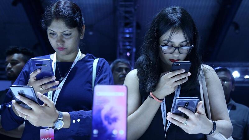 Visitors checking the new phones of OnePlus 7 series during a launch event in Bangalore in May, last year. EPA