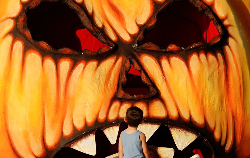 A child looks at a giant Halloween pumpkin made from papier-mache in Valletta, Malta. Reuters