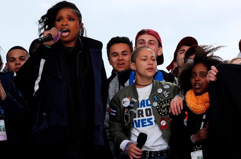 Singer Jennifer Hudson performs alongside Emma Gonzalez (2nd from R), from Marjory Stoneman Douglas High School in Parkland, Florida, and 11-year-old Naomi Wadler of Alexandria, Virginia (R). Reuters