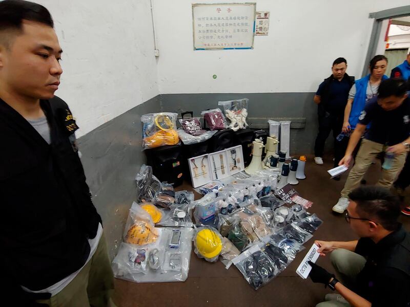 Confiscated equipments and weapons are displayed in Hong Kong on Saturday, July 20, 2019. Police in Hong Kong have raided a homemade-explosives manufacturing lab ahead of another weekend of protests in the semi-autonomous Chinese territory. (Apple Daily via AP)