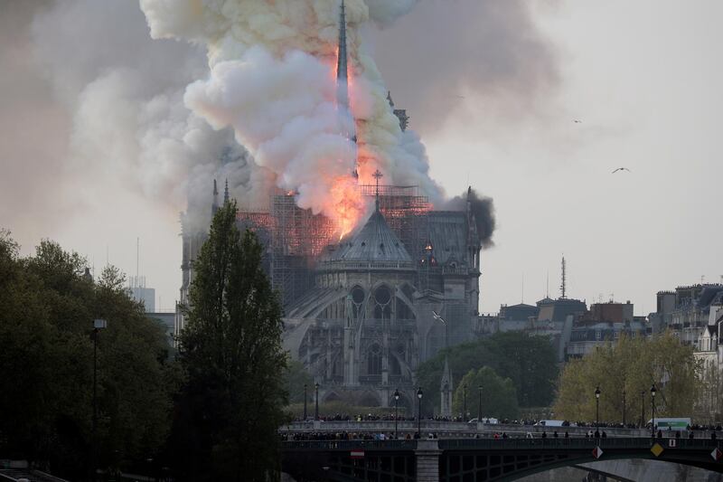 Smoke and flames rise during a fire at the landmark Notre-Dame Cathedral in central Paris on April 15, 2019.  EPA