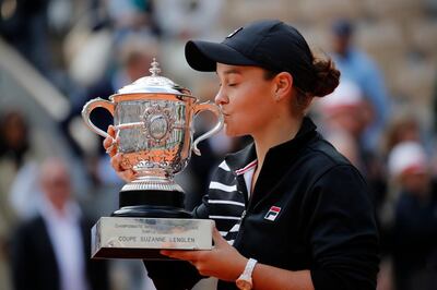 Australia's Ashleigh Barty kisses the trophy as she celebrates winning her women's final match of the French Open tennis tournament against Marketa Vondrousova of the Czech Republic in two sets 6-1, 6-3, at the Roland Garros stadium in Paris, Saturday, June 8, 2019. (AP Photo/Christophe Ena)